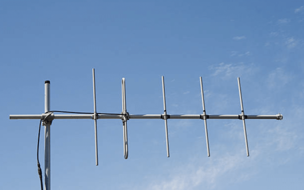 Screenshot 2026-03-14 at 115151 - N9BO℠ | Global Underwater Services Ltd A rooftop TV aerial with multiple horizontal metal rods is mounted on a pole against a clear blue sky with light clouds.