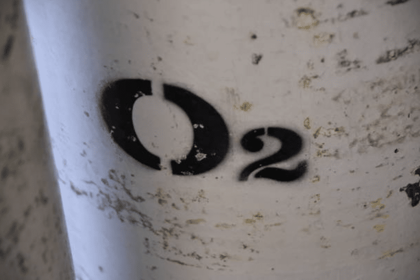 Screenshot 2026-03-14 at 153801 - N9BO℠ | Global Underwater Services Ltd A close-up of a white cylinder with chipped paint, featuring the text O2 stencilled in black, indicating it contains oxygen.