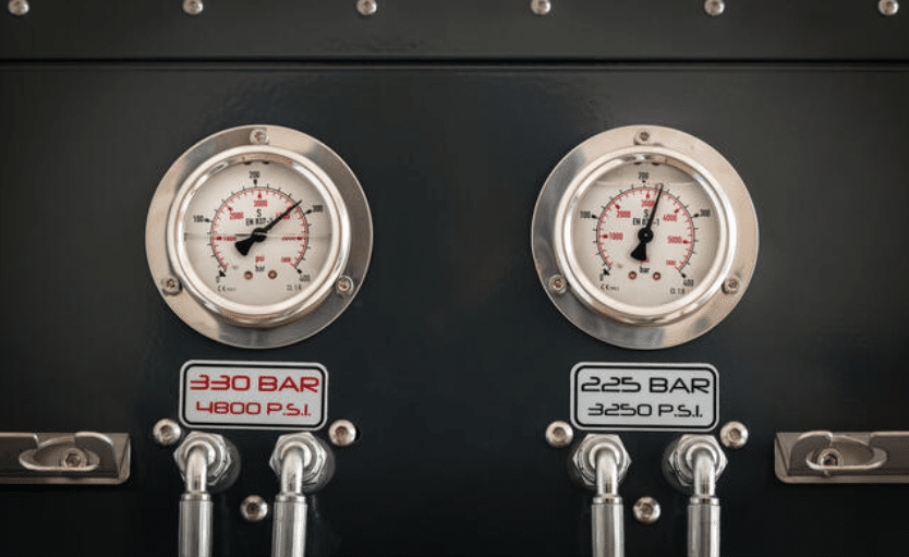 Screenshot 2026-04-02 152831 - N9BO℠ | Global Underwater Services Ltd Close-up of two industrial pressure gauges on a black panel, displaying readings in BAR and PSI. The left gauge is labelled 330 BAR / 4800 PSI, and the right one is labelled 225 BAR / 3250 PSI.